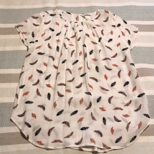 Beautiful white blouse with print feathers